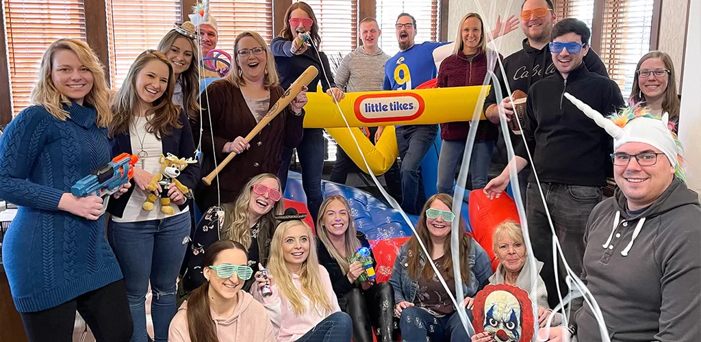 Krause Group staff celebrates Have Fun At Work Day with silly props and attire